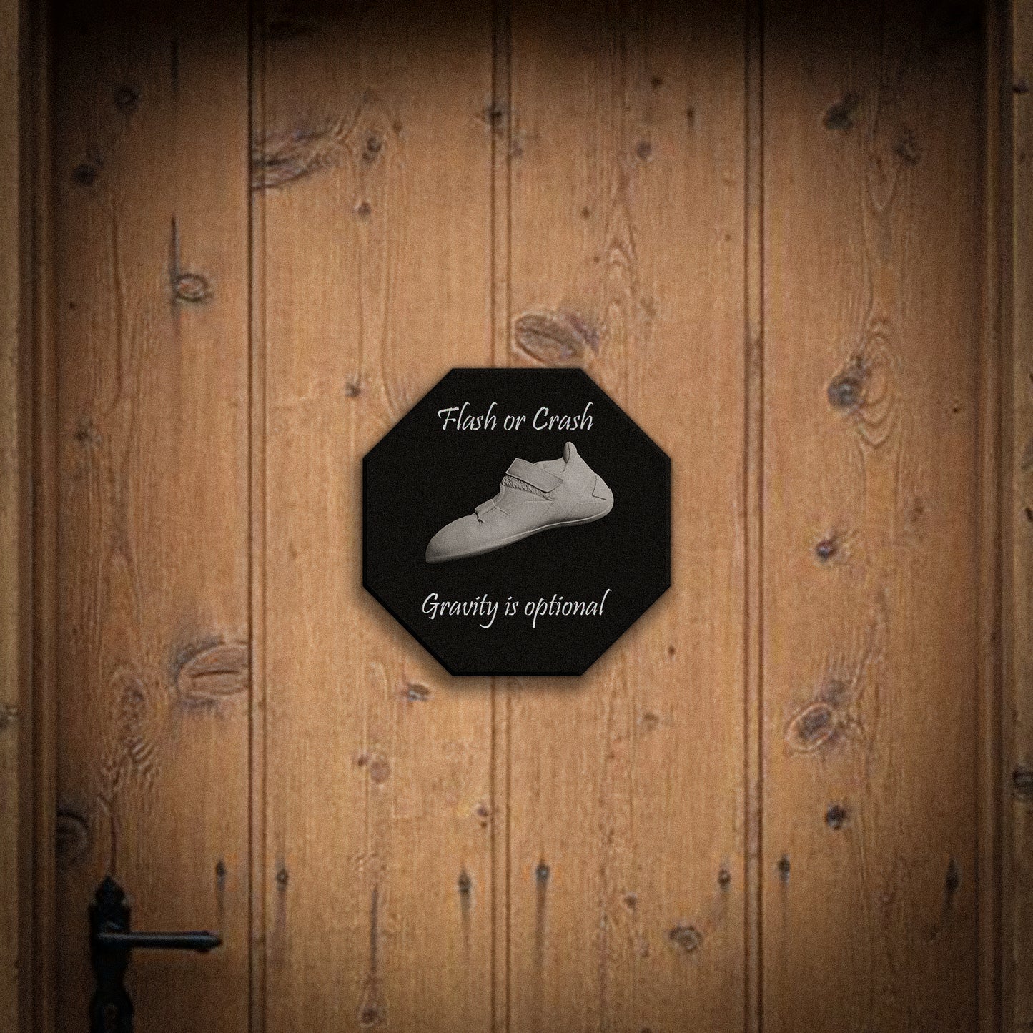 Octagonal sign with a climbing white shoe and text on a wooden door