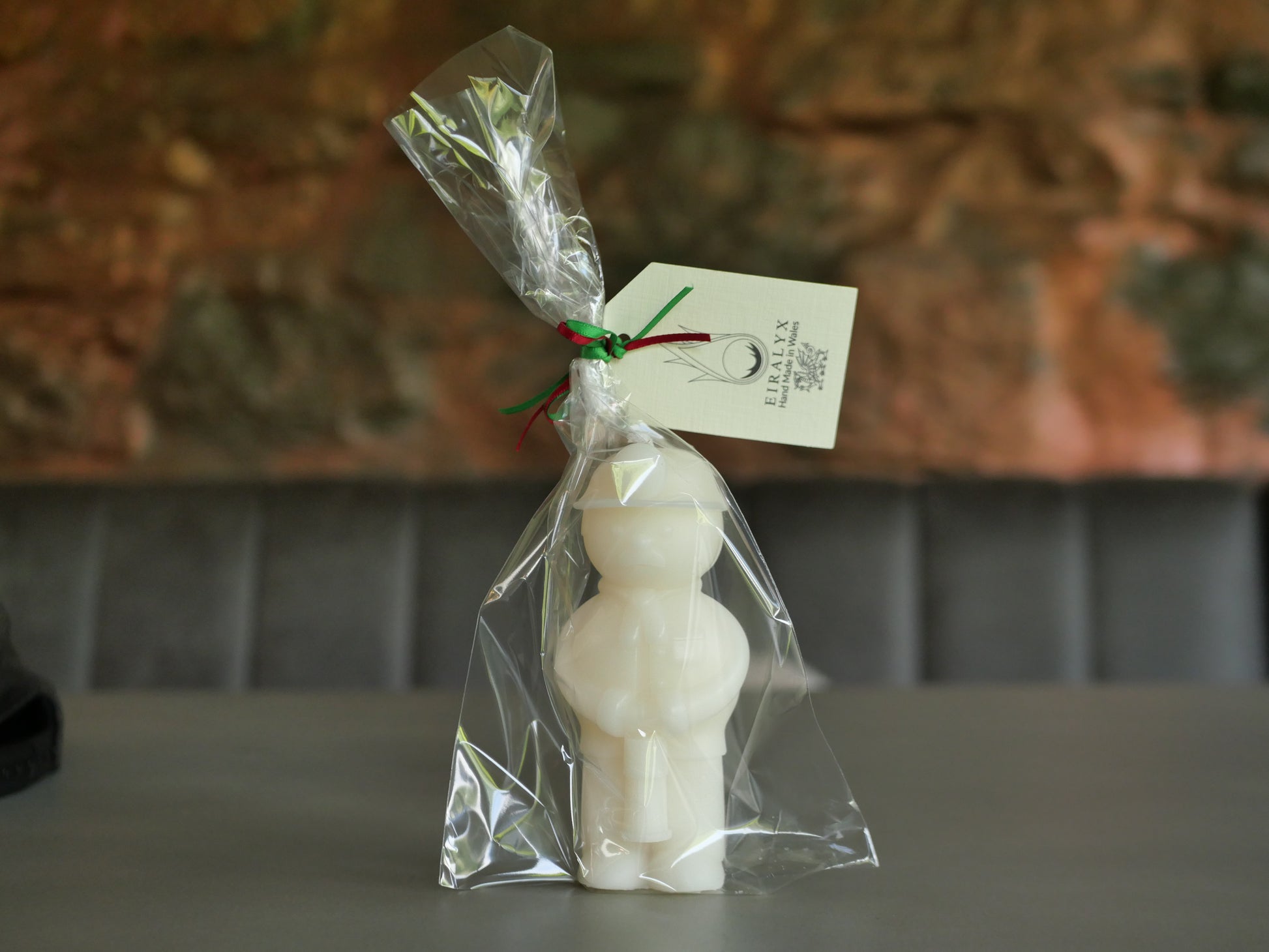 welsh miner candle in clear plastic packaging with a tag