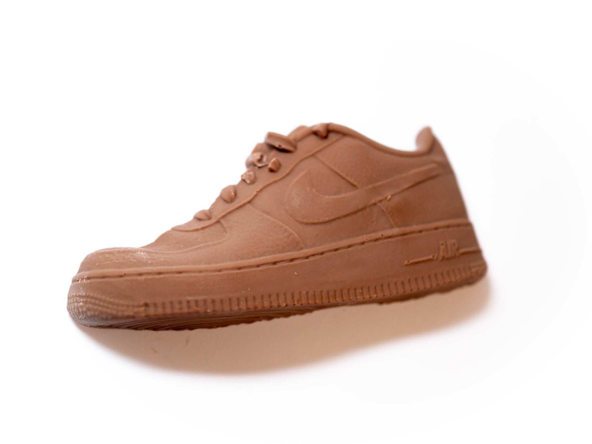 A trainer shoe made out of chocolate.