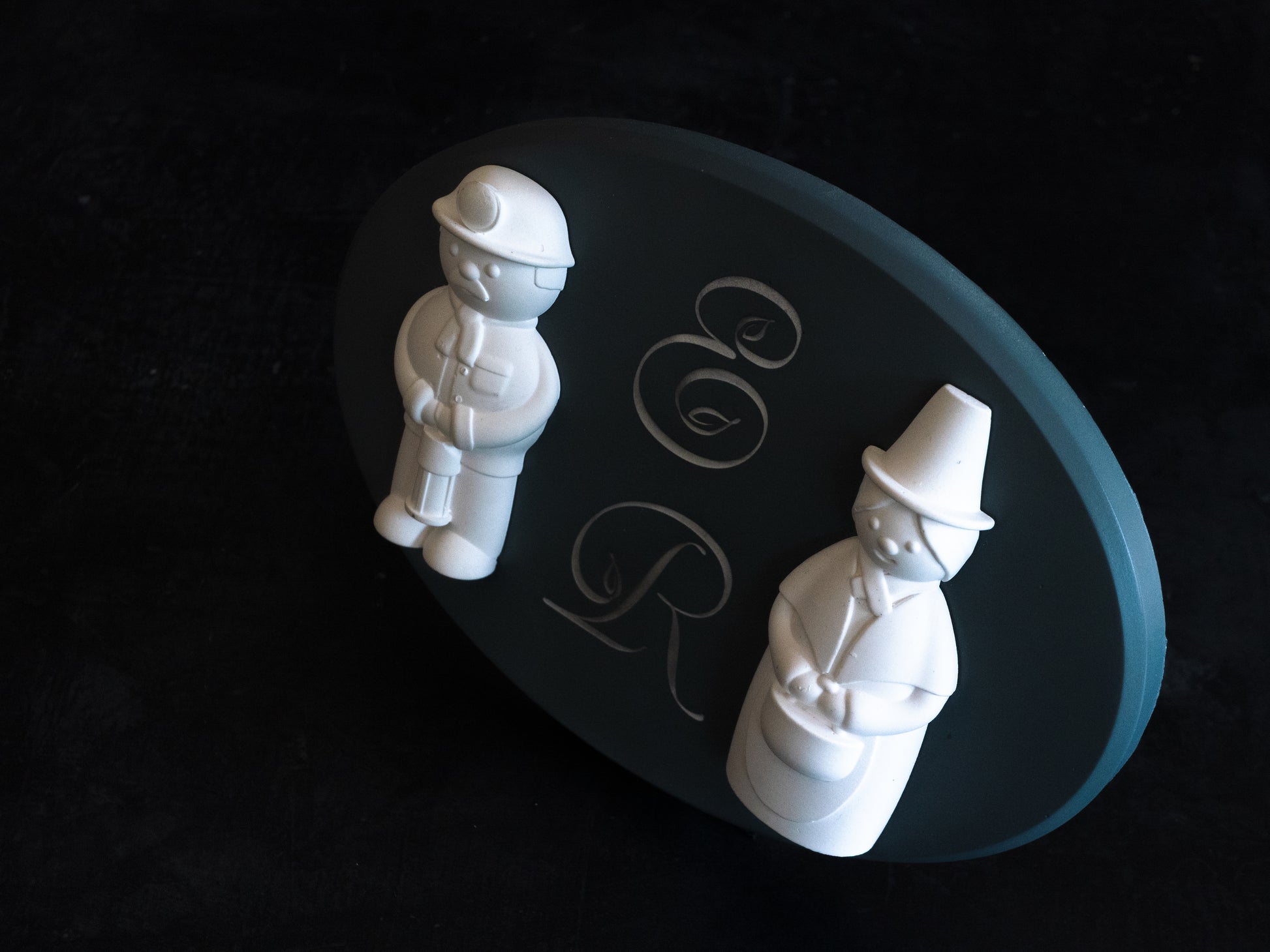 Welsh Miner and Welsh Lady Figurines on an oval plaque with desk plinth