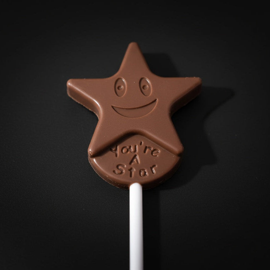 Chocolate star lollipop with a smiley face and 'You're a Star' text on a black background