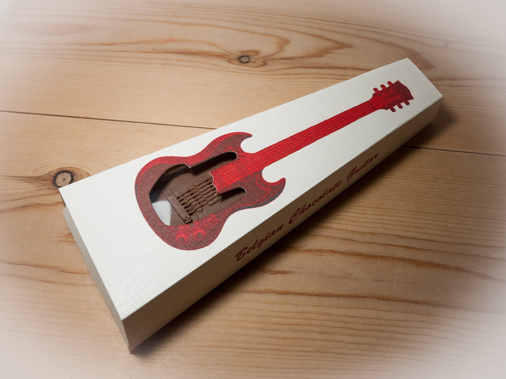 A Gibson SG shaped chocolate in a gift box.
