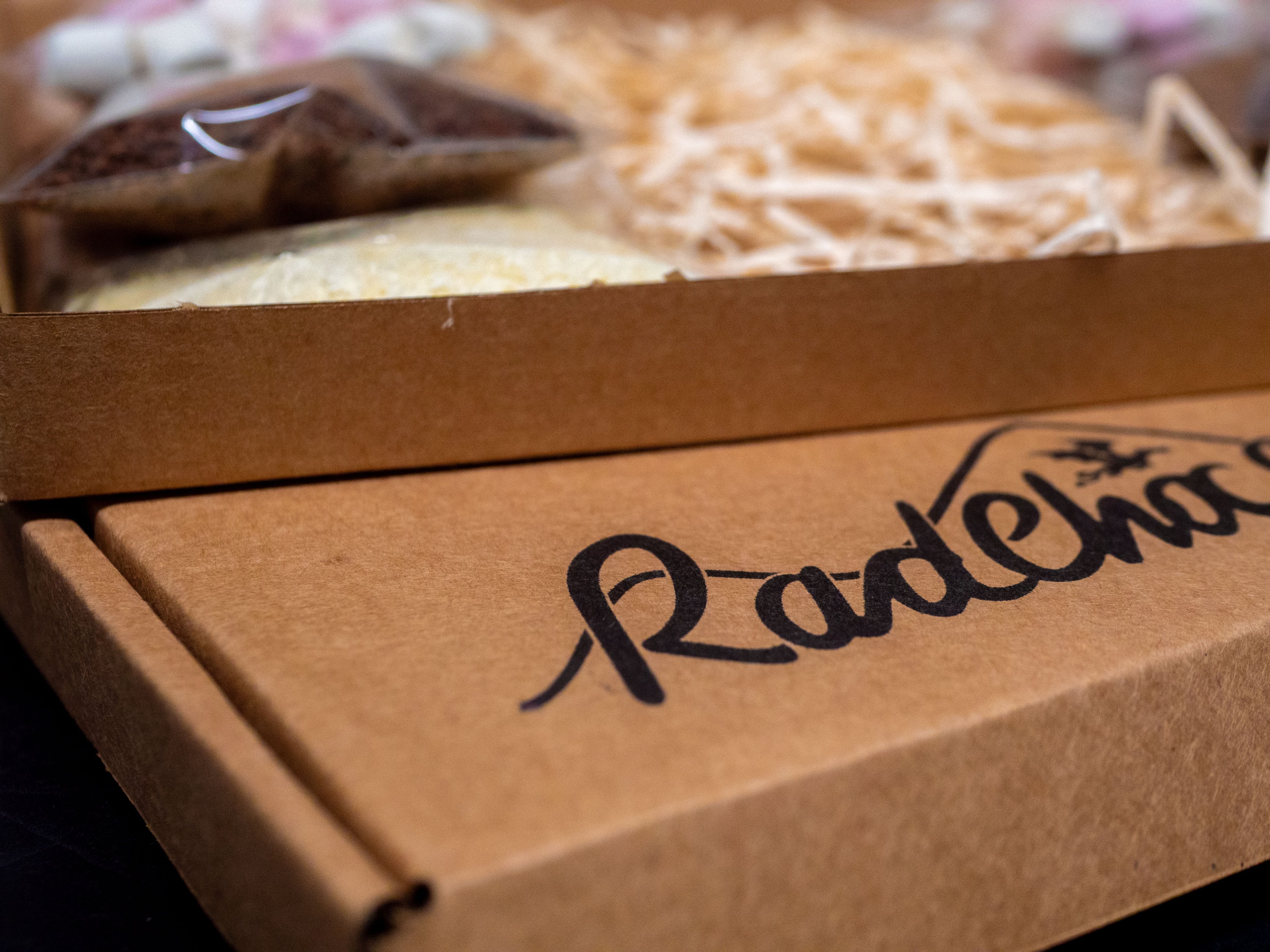Brown cardboard box with 'RadChoc' branding on a blurred background