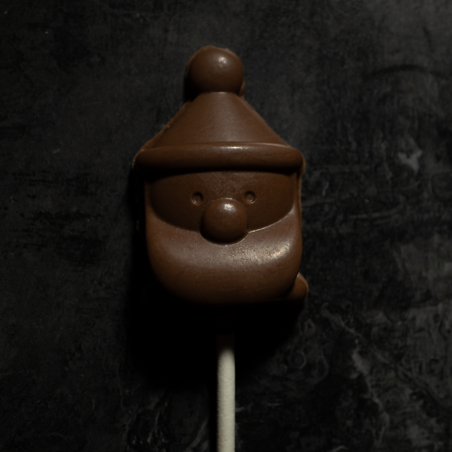 A santa shaped chocolate lollipop.